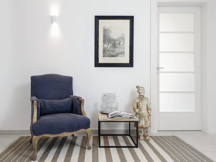 Bright Montreal home interior with a navy armchair